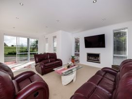 A living room with a sofa and a coffee table at Solar House - Kerikeri Holiday House in Kerikeri