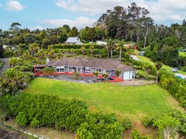 A house with a garden and landscaped area at Solar House - Kerikeri Holiday House in Kerikeri