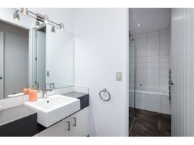 A bathroom with a sink and a shower at Solar House - Kerikeri Holiday House in Kerikeri