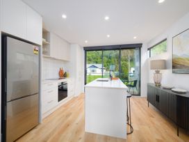 A kitchen with modern appliances and an island at Ocean Whisper Retreat - Kaikoura Holiday Home, Kaikoura