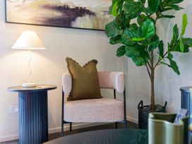 A living room with a chair and lamp at Ocean Whisper Retreat - Kaikoura Holiday Home Kaikoura