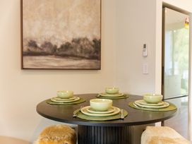 A dining table with soup bowls and plates at Ocean Whisper Retreat - Kaikoura