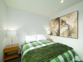 A bedroom with a bed and lamps at Ocean Whisper Retreat - Kaikoura Holiday Home Kaikoura