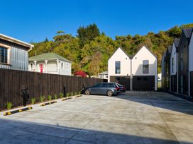 An outdoor area with parked car and houses at Ocean Whisper Retreat - Kaikoura Holiday Home Kaikoura