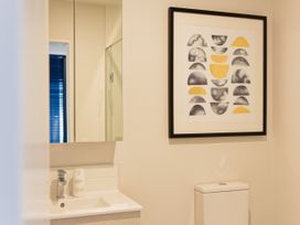 A bathroom with a sink and mirror at Ocean Whisper Retreat - Kaikoura