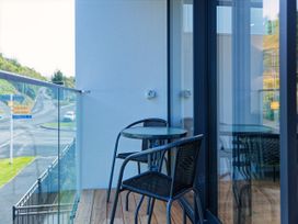 A balcony with a table and chairs at Ocean Whisper Retreat - Kaikoura