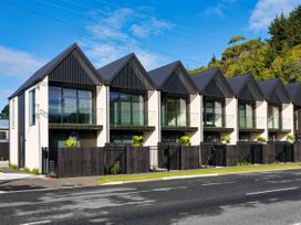A row of modern buildings with balconies at Ocean Whisper Retreat - Kaikoura Holiday Home, Kaikoura