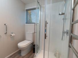 A bathroom with a shower and toilet at Arrowtown Gold - Elevated Two Bedroom Apartment in Arrowtown