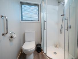 A bathroom with a shower and toilet at Arrowtown Gold - Elevated Two Bedroom Apartment in Arrowtown