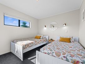 A bedroom with two beds and a window at Papamoa Waves - Seaside Getaway, Papamoa