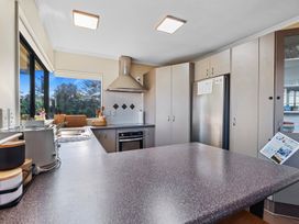 A kitchen with a refrigerator and stove at Papamoa Waves - Seaside Getaway, Papamoa