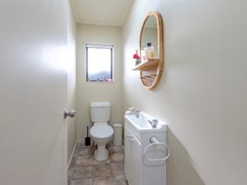 A bathroom featuring a toilet and sink at Papamoa Waves - Seaside Getaway in Papamoa