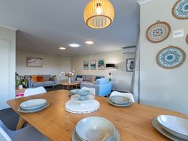 A living room with a sofa and coffee table at Papamoa Waves - Seaside Getaway in Papamoa