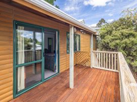 An outdoor deck with a wooden railing at Alpine Charm - Ohakune Holiday Home Ohakune