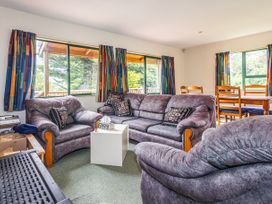 A living room with sofas and a dining table at Alpine Charm - Ohakune Holiday Home in Ohakune