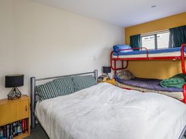 A bedroom with a bunk bed and a double bed at Alpine Charm - Ohakune Holiday Home in Ohakune