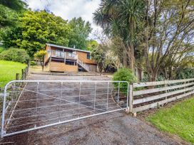 A house with a gate and trees at Alpine Charm - Ohakune Holiday Home in Ohakune