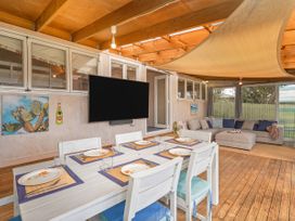 A dining room with table and chairs at Home Away From Home In Whangamata