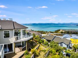 A view of houses and ocean from a balcony at Wellington Holiday in Wellington