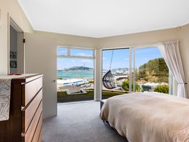 A bedroom with a view and hammock at Wellington Holiday in Wellington