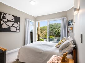 A bedroom with a bed and large window at Wellington Holiday in Wellington