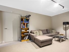 A snug with a sofa and bookshelf at Wellington Holiday in Wellington