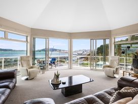 A living room with large windows and a sea view at Wellington Holiday in Wellington