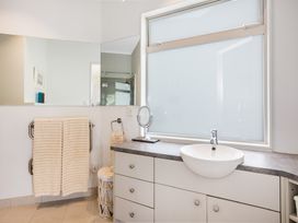A bathroom with a sink and a mirror at Wellington Holiday in Wellington