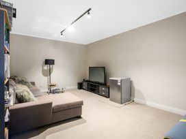 A living room with a sofa and television at Wellington Holiday in Wellington