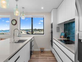 A kitchen with a sink and window at Kawau Bay Escape - Snells Beach