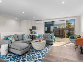 A living room with a sofa and coffee table at Kawau Bay Escape - Snells Beach