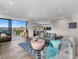 A living room with a sofa and coffee table at Kawau Bay Escape - Snells Beach