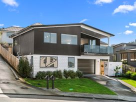 A house with a garage and balcony at Kawau Bay Escape - Snells Beach