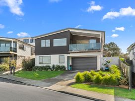 A house with a front yard and balcony at Kawau Bay Escape - Snells Beach