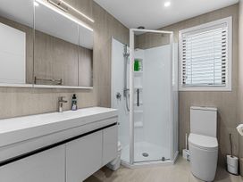 A bathroom with a shower and sink at Kawau Bay Escape - Snells Beach