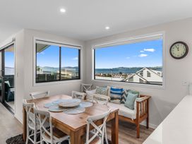 A dining room with a table and chairs at Kawau Bay Escape - Snells Beach Holiday Home