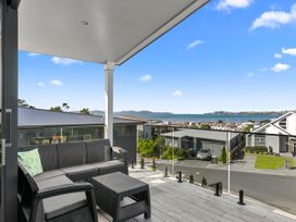 An outdoor patio with a sofa and coffee table at Kawau Bay Escape - Snells Beach Holiday Home, Snells Beach