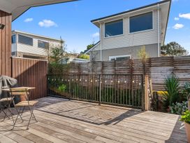 An outdoor area with a deck and grill at Kawau Bay Escape - Snells Beach