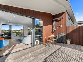 An outdoor area with a table and chairs at Kawau Bay Escape - Snells Beach