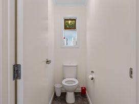A bathroom with a toilet and a window at Turangi Holiday Home in Turangi