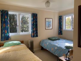 A bedroom with two beds and a window at Singlee - Turangi Holiday Home, Turangi