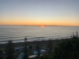 A sunset view over the sea at Cape View - Napier Holiday Home in Bluff Hill