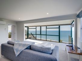 A living room with a view of the ocean at Cape View - Napier Holiday Home Bluff Hill