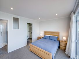 A bedroom with a bed and nightstands at Cape View - Napier Holiday Home Bluff Hill