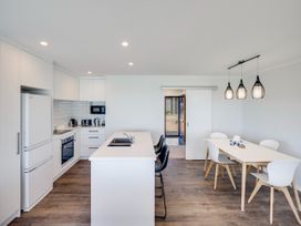 A kitchen with appliances including refrigerator and stove at Cape View - Napier Holiday Home Bluff Hill