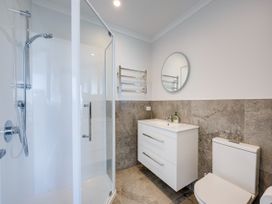 A bathroom with shower and toilet at Cape View - Napier Holiday Home, Bluff Hill