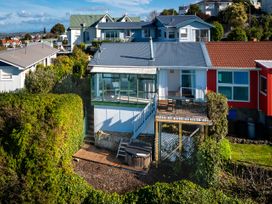 A house with a deck and hot tub at Cape View - Napier Holiday Home Bluff Hill
