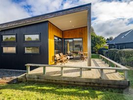 An outdoor deck area of a house with chairs at Alpine Retreat - Ohakune Holiday Home in Ohakune