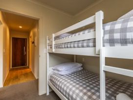 A bedroom with a bunk bed and pillows at Alpine Retreat - Ohakune Holiday Home in Ohakune