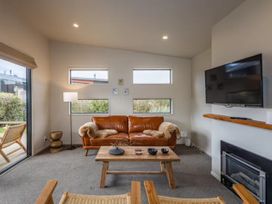 A living room with a sofa and coffee table at Alpine Retreat - Ohakune Holiday Home in Ohakune
